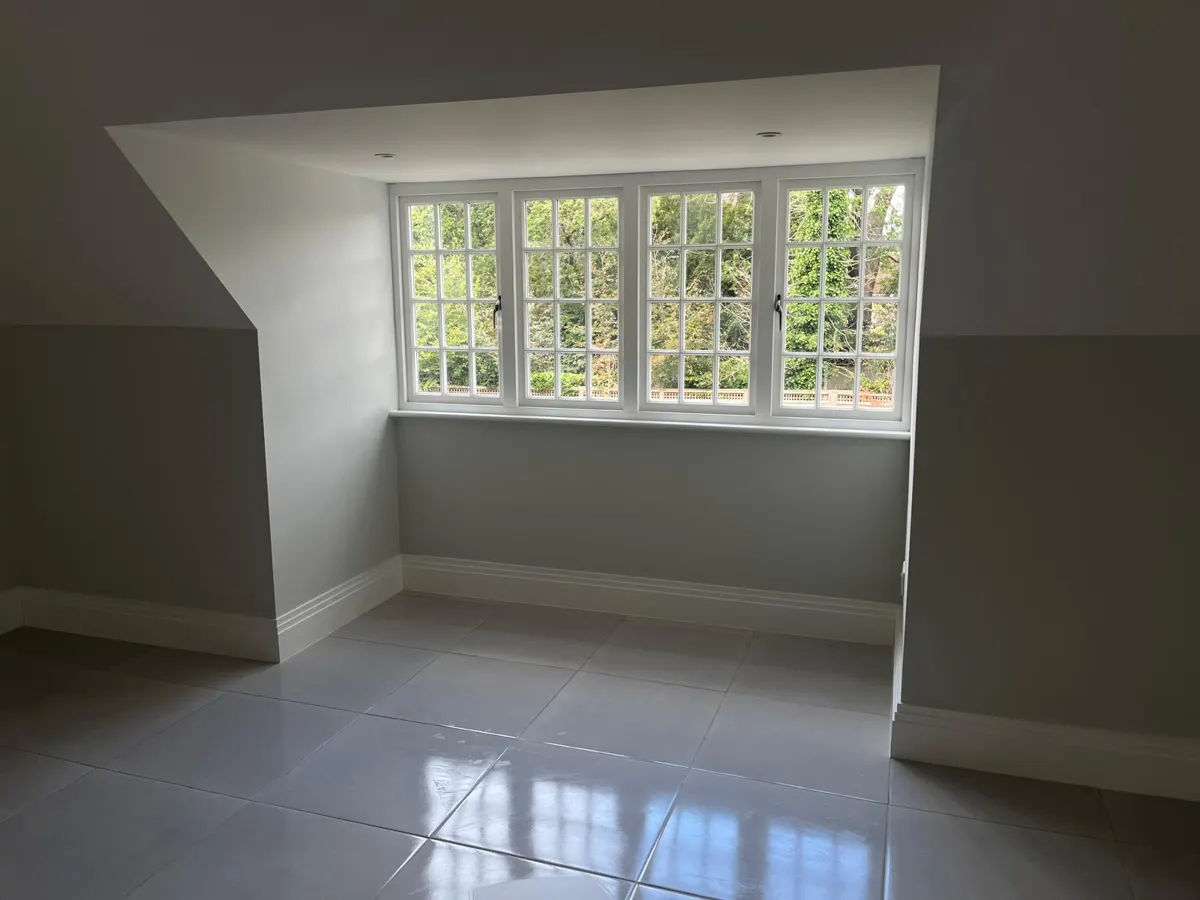 Bright empty room with leaded windows and shining tiled floor